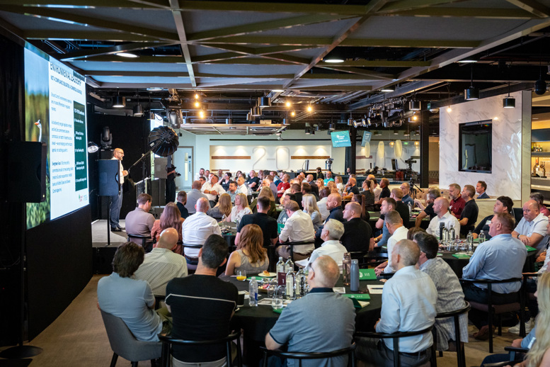 Audience attending a presentation at a business conference event.